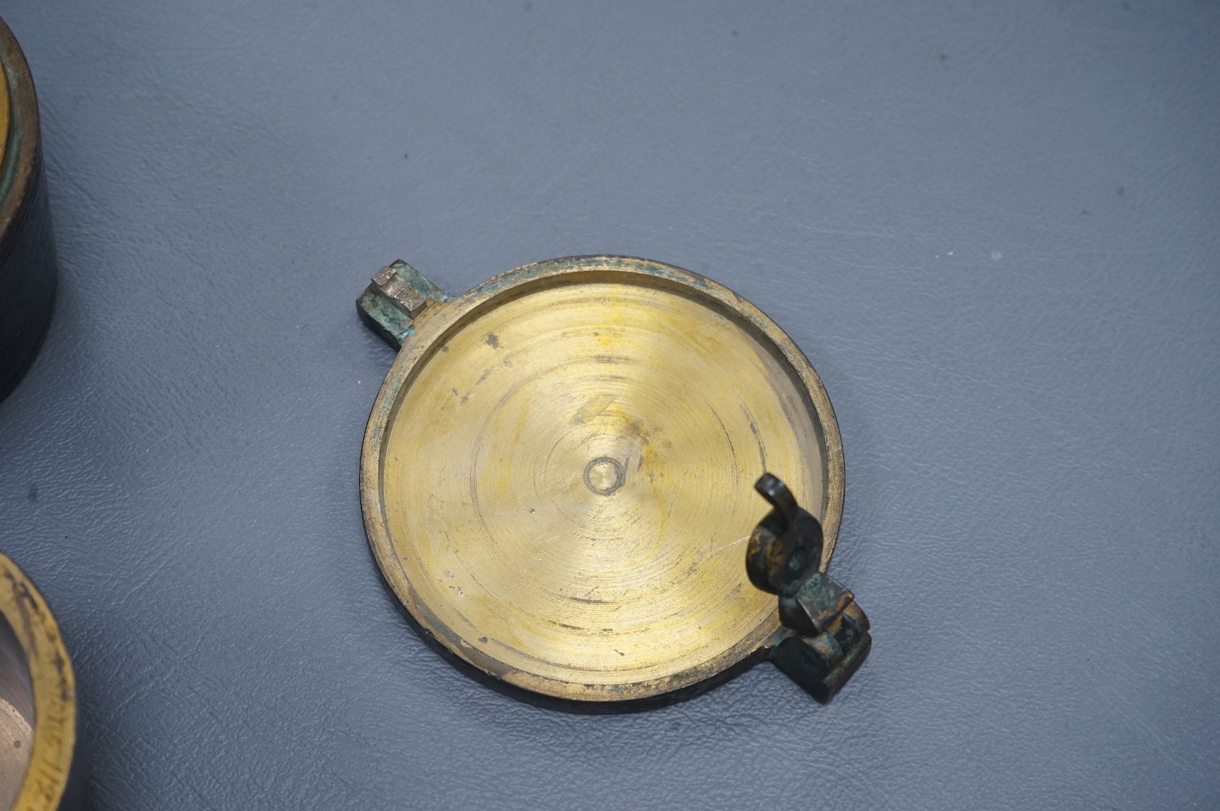 A 19th century brass nest of weights, the case with engraved inscription, 18 stone/4lb, Weeks’s Mechl. Museum, Tichborne St., 10cm wide